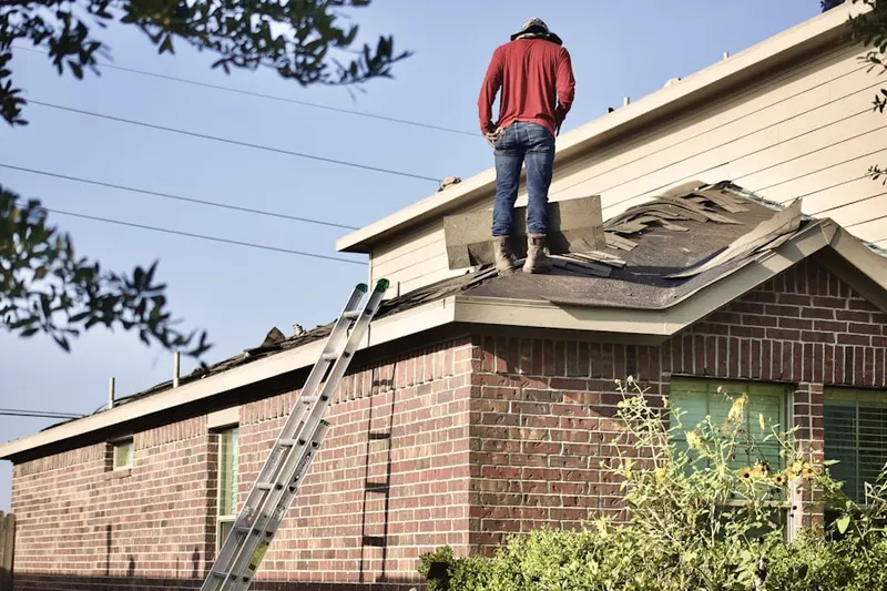 Professional roofer working on a residential roof in Whitemarsh Hunt